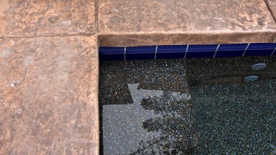 Up close view of stone work surrounding a pool Photo